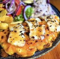 Hot honey and halloumi parmo served with salad and chips at The Wellington Inn