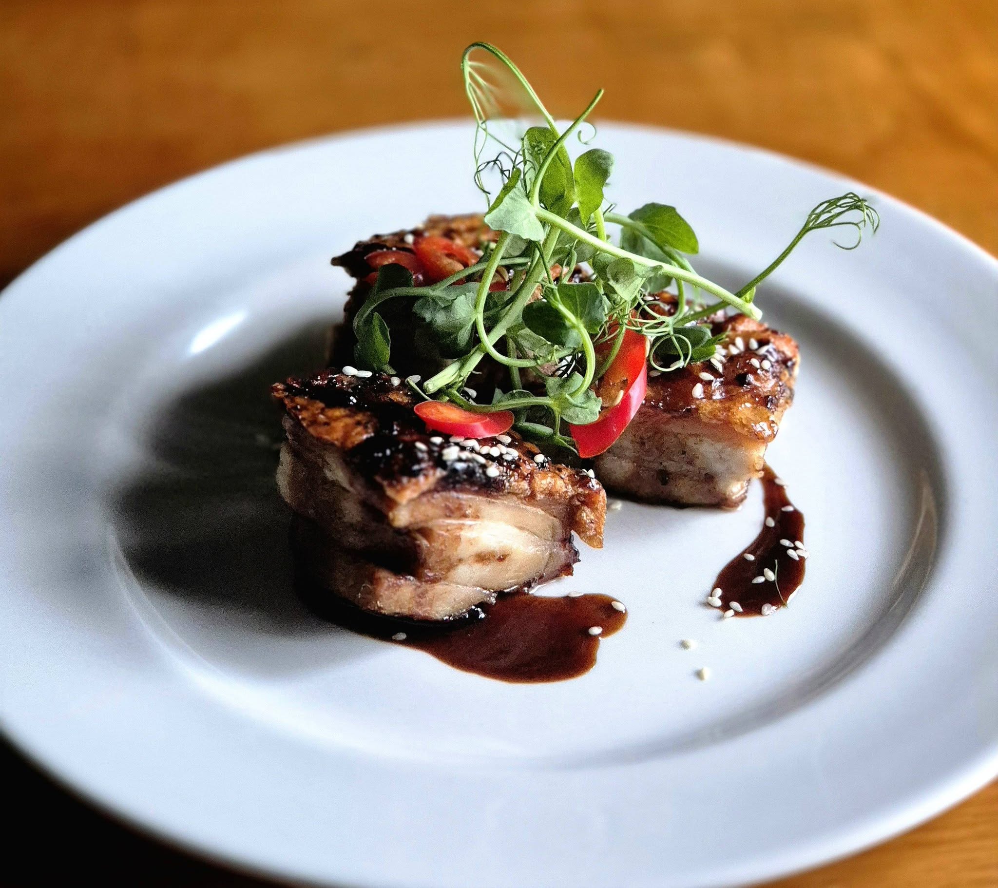 Salt and pepper pork belly bites with sesame, chilli and pea shoots