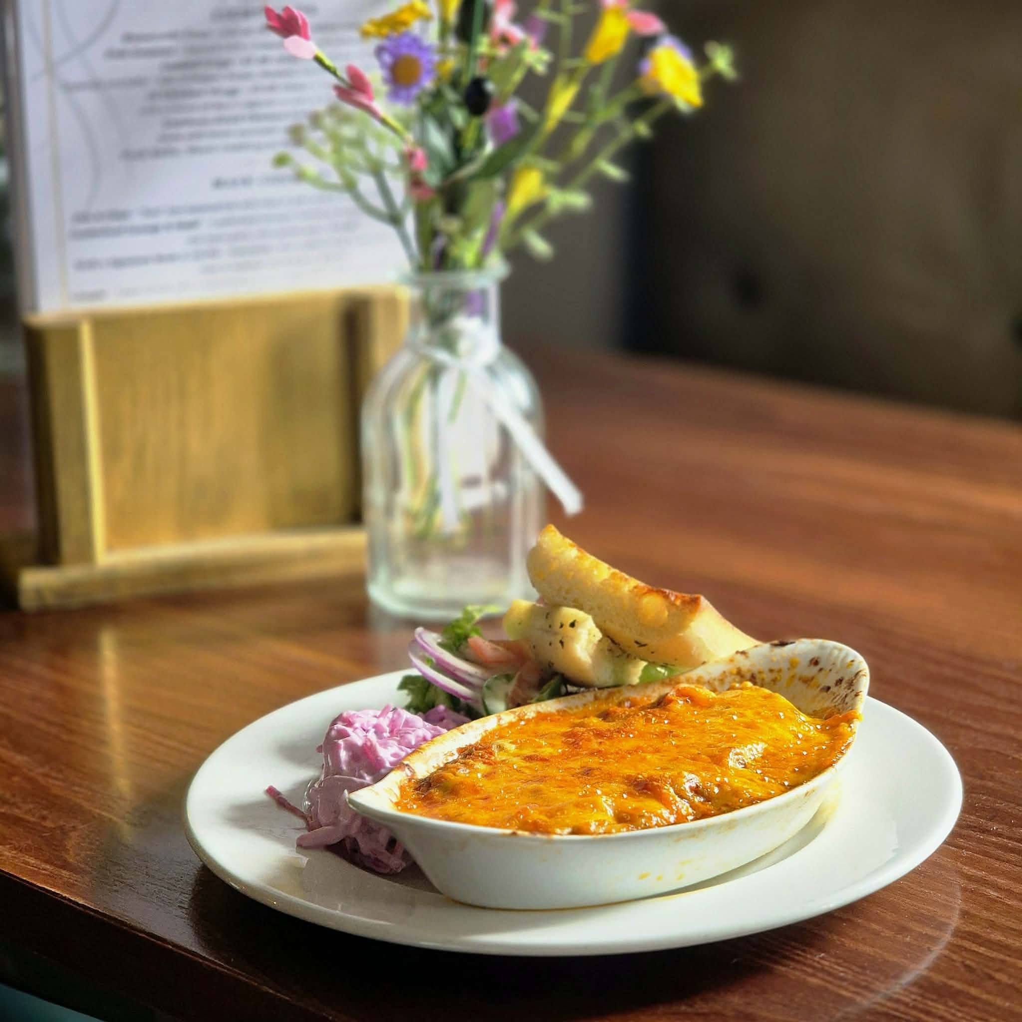 Homemade lasagne served with salad, coleslaw and garlic bread at The Wellington Inn